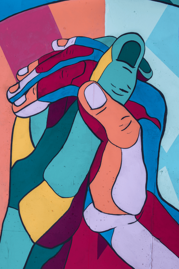 Image of multiple hands joining together in unity.